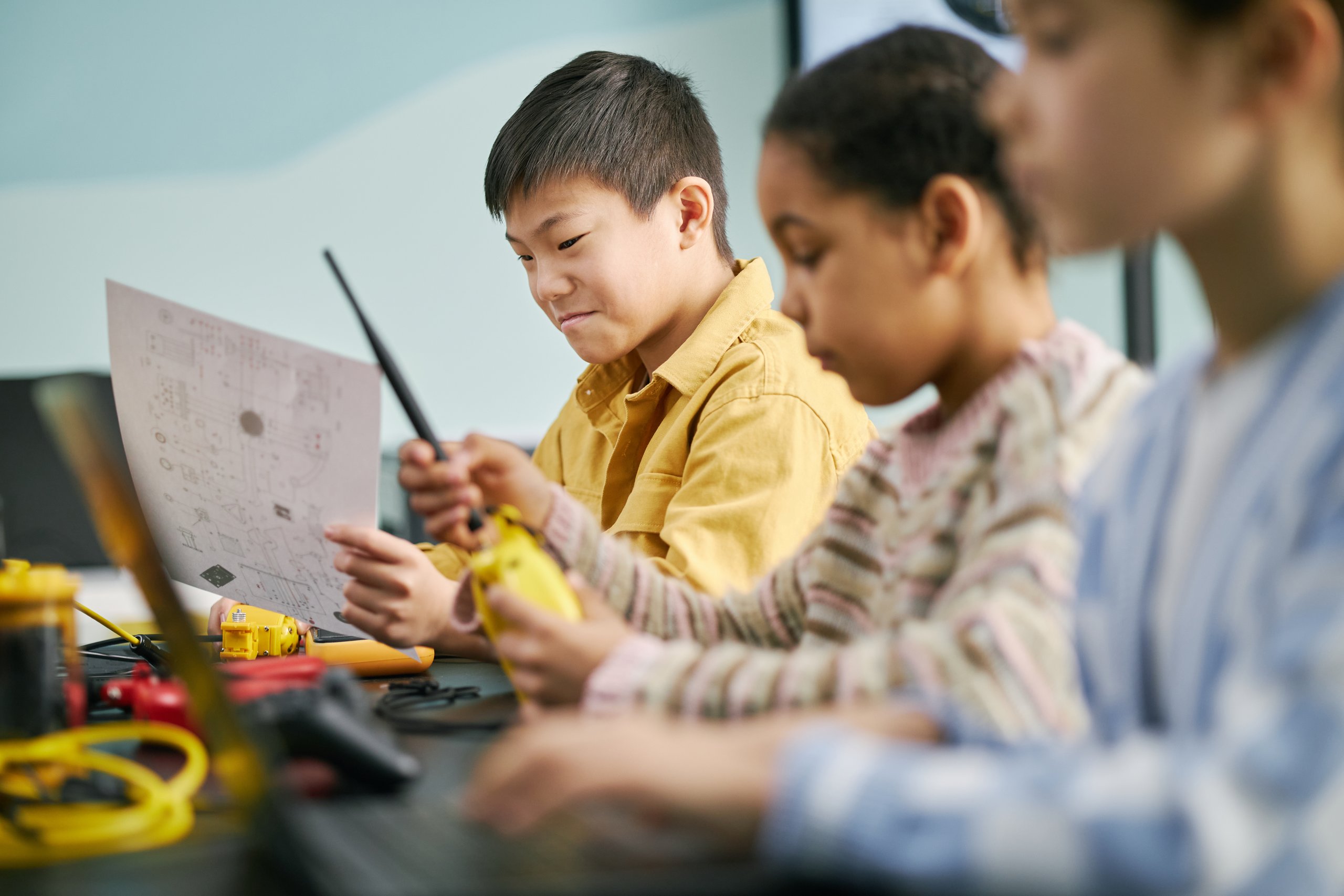 Young male students collaborating on science projects, hands-on STEM learning and teamwork