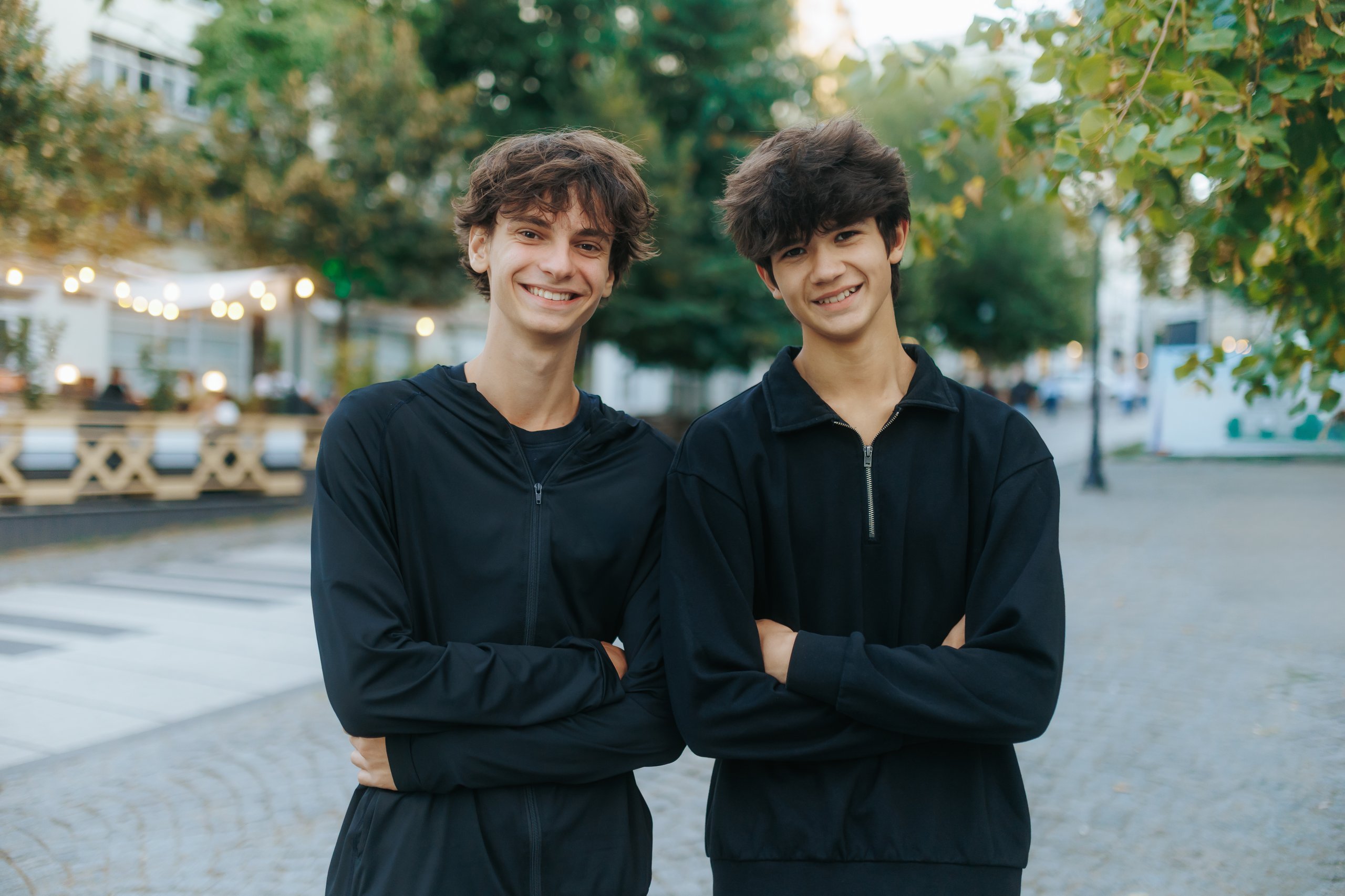 Two teenage friends posing confidently together outdoors, positive youth friendship